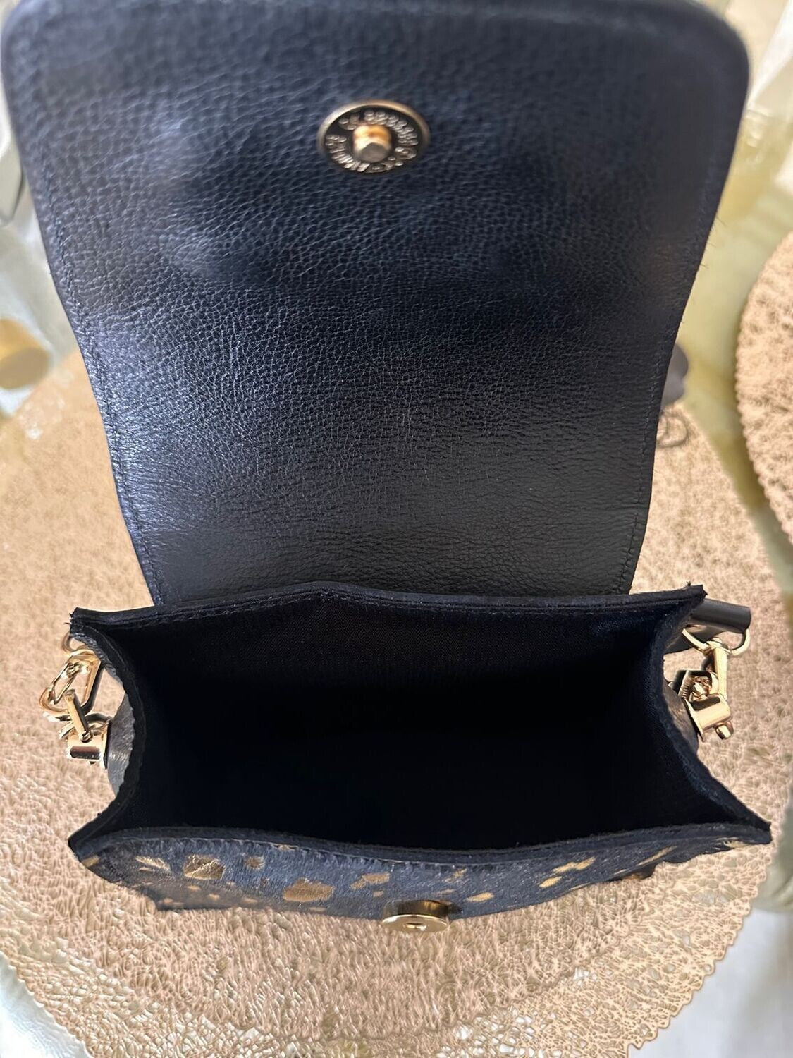 The Kiki Handbag in hair-on leather with gold chain strap and sleek design