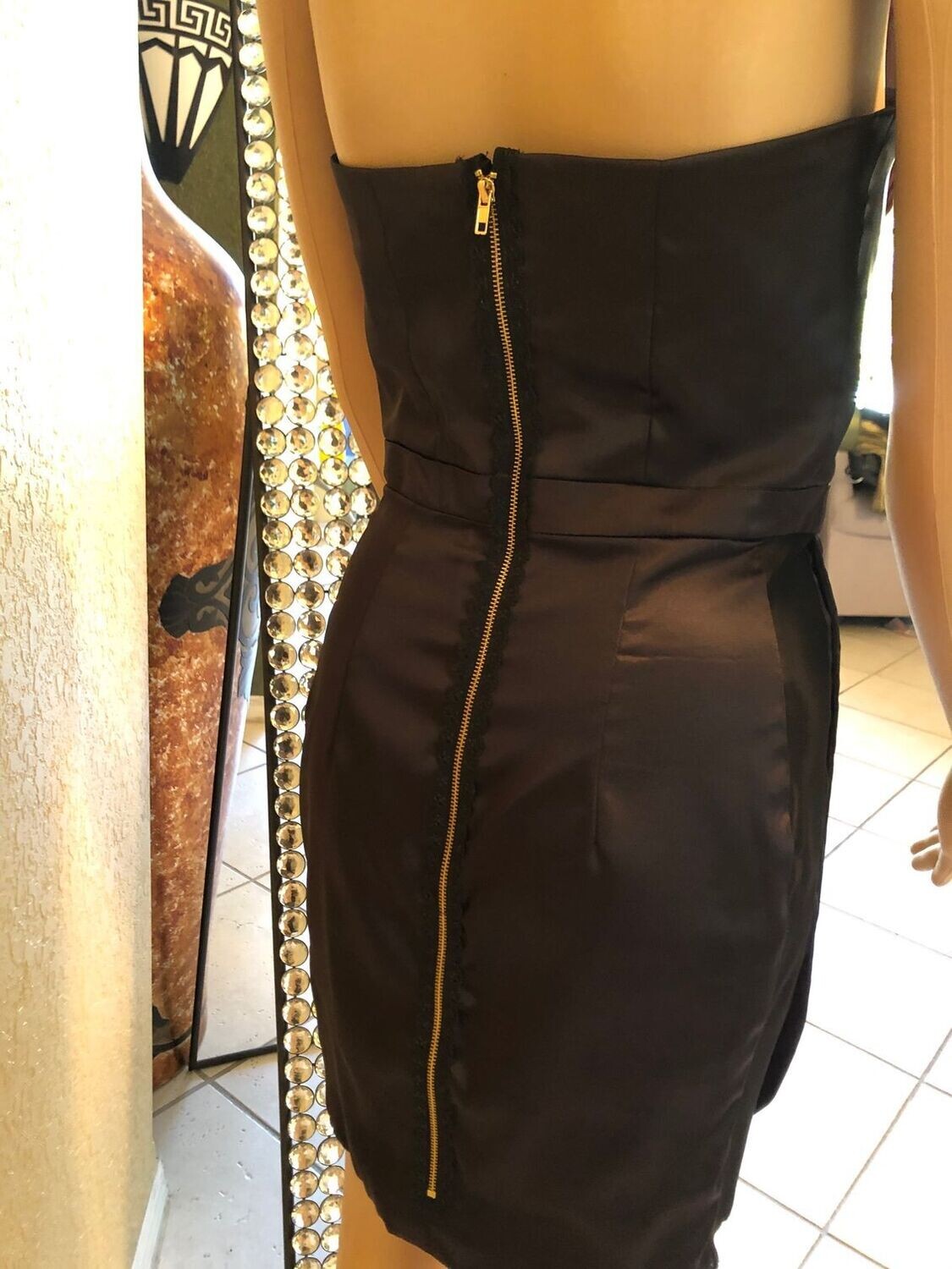 Luxury formal black dress with figure-sculpting bodice and mesh sides