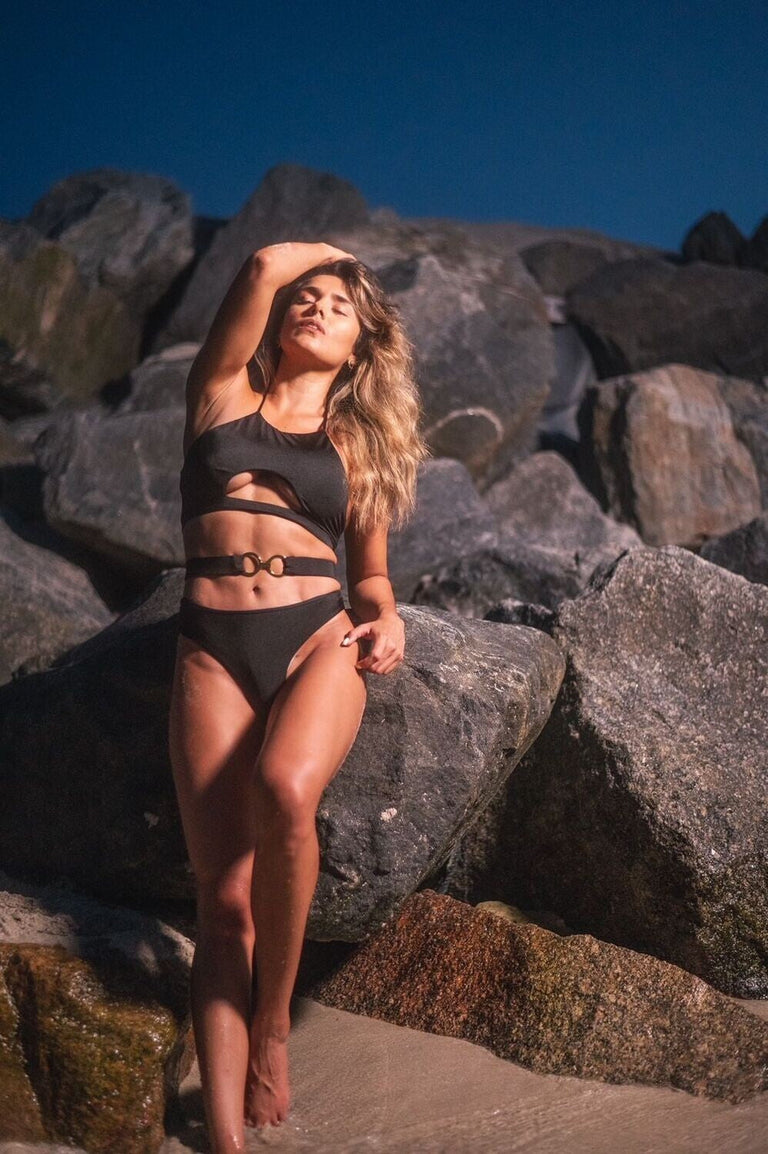 Model wearing black luxury three-piece swimsuit by Belle D’Amour
