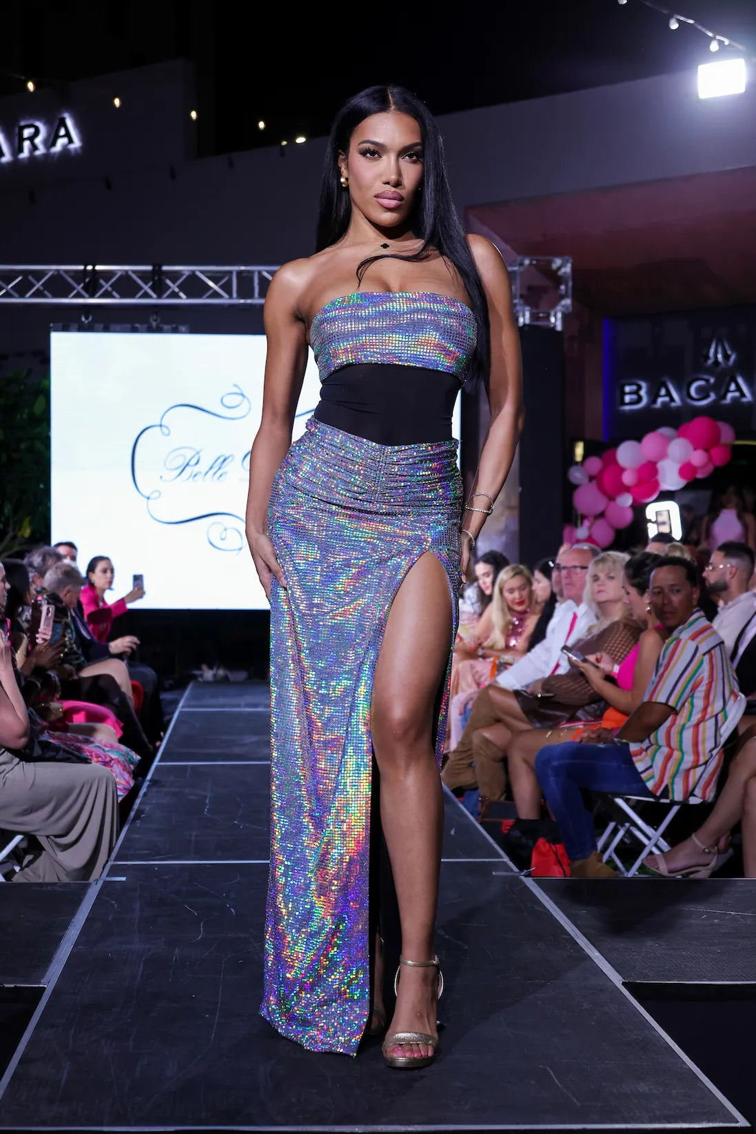 Runway shot of The Belle D’Amour Celestial Rêve Dress highlighting its radiant fabric and celestial-inspired movement under the lights