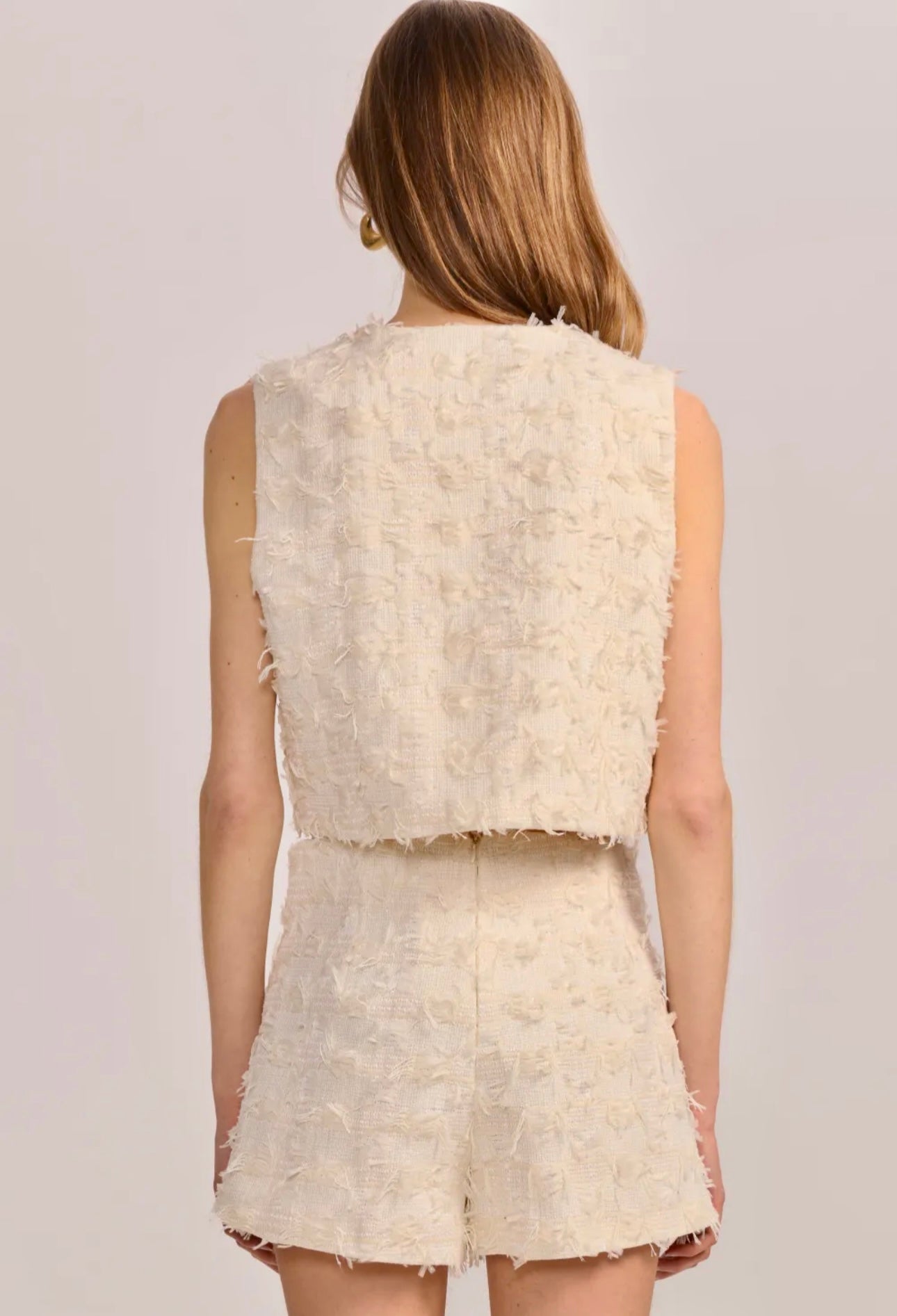 Model wearing The Gabrielle Vest in cream styled for an elegant, polished look