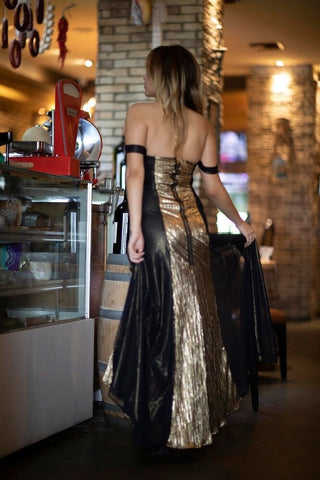 Designer formal gown by Belle D’Amour featuring gold plissé and black mesh overlay