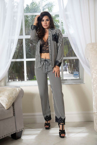 Flat lay of The Black Tie Set two-piece outfit showcasing shirt and pants with lace and stripe details