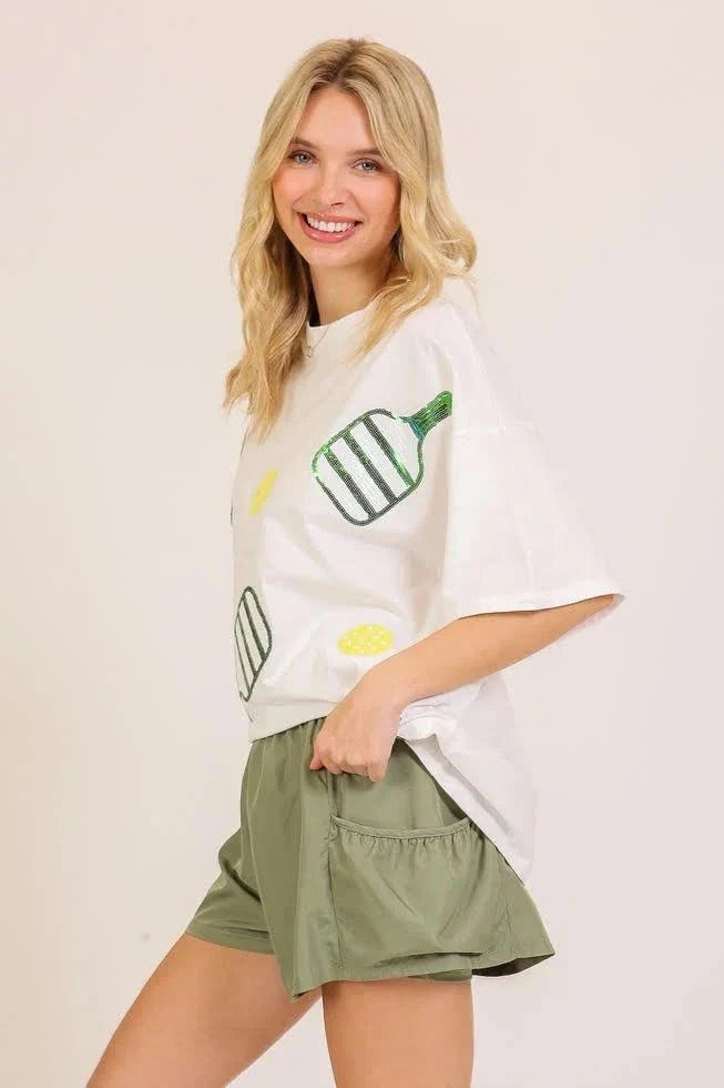 Sequin Pickleball oversized white cotton T-shirt with green paddles and yellow ball graphic, short sleeves
