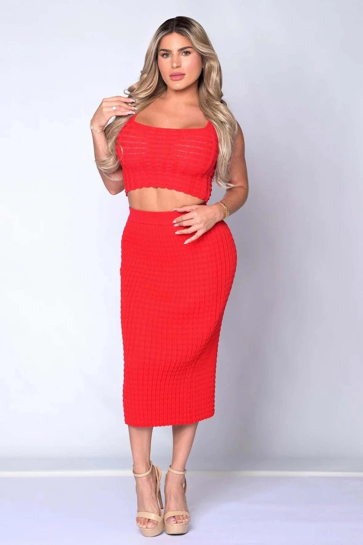 Woman wearing The Sabrina Skirt Set in stretch waffle knit, featuring sleeveless fitted top and body-hugging midi skirt