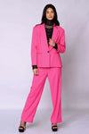 The Runway Boxy Blazer in vibrant raspberry pink with a relaxed, boxy silhouette and single-button closure worn with matching pants.