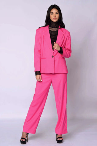 The Runway Boxy Blazer in vibrant raspberry pink with a relaxed, boxy silhouette and single-button closure worn with matching pants.