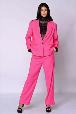 The Runway Boxy Blazer in vibrant raspberry pink with a relaxed, boxy silhouette and single-button closure, styled with matching wide-leg pants.