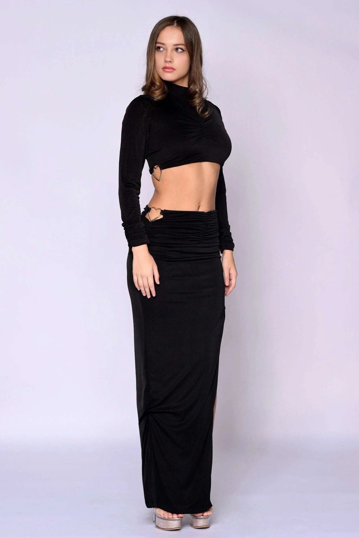 The Mon Bebe Skirt Set, black stretch two-piece with long-sleeve cropped top and ruched maxi skirt with slit